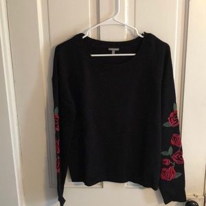 Black sweater with rose detailed sleeves
